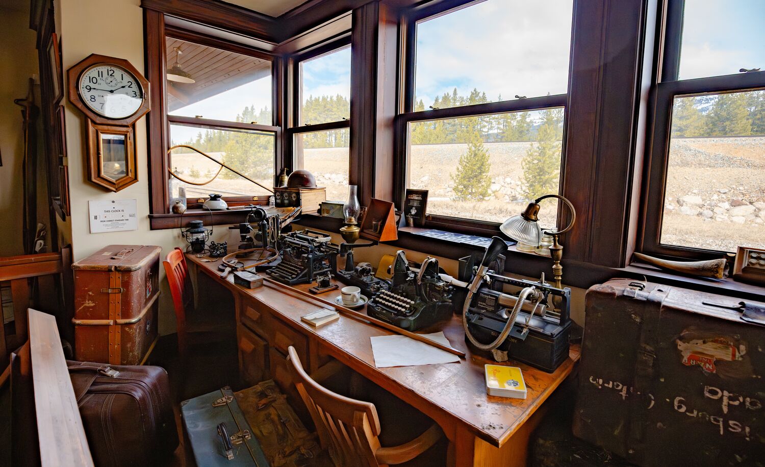 The Station Restaurant in Lake Louise Master Room with vintage desk, morse code machine, and historic railway artifacts